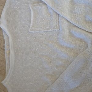 Cotton sweater with high/low waist...distressed edge on cuffs and hem.